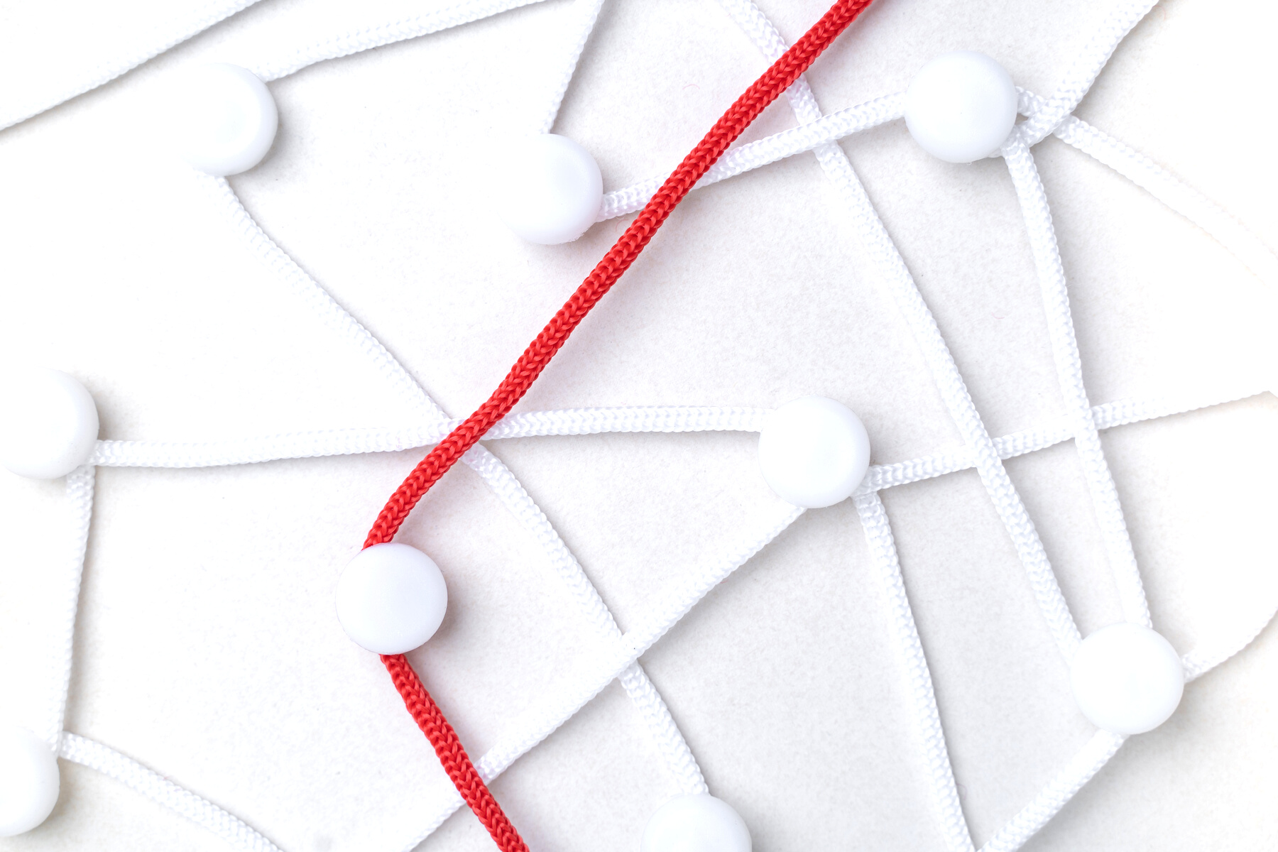 Red Rope Among White Ones with Push Pins